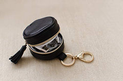 Itzy Ritzy Pacifier Case with Clip – Pacifier Charm Pod Includes Clasp to Easily Attach to a Diaper Bag or Purse; Measures 2.5” in Diameter and Holds 2 Pacifiers, Black